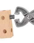 A gray plastic snap hook clip with a silver screw fastener, shown holding a small light wood block with circular holes, on a plain white background.