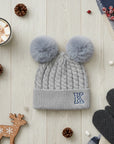 Grey knitted beanie with double pom-poms