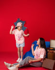 mother and child in front of red backdrop