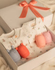 baby gift set with twinning sleepsuits, blankets and bath toys in sleepy cats and white floral bunny