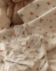 twins matching sleepsuits and blankets in sleepy cats and white floral bunny