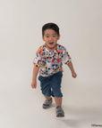 Child wearing pop comic mickey tee on a white background