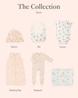 Baby clothing collection including a beanie, bib, onesie, sleeping bag, and sleepsuit on a light pink background.