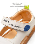 Tip Toey Joey Explore Born to Move Sandals in Tapioca showing the thin, flexible sole for feeling the ground