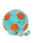 Plush toy soccer ball with a smiling face on a white background