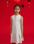 Girls' Naomi Cheongsam by Elly in Zodiac Mahjong print against a red background.