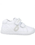 White children's shoe with velcro straps on a white background