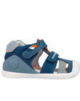 Blue children's sandal with white sole on a white background