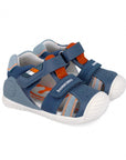 Blue children's sandal with orange accent and white sole on a white background