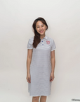 Woman wearing stripes sailor mickey polo dress with a logo on a white background