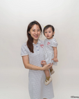 Woman holding a child both wearing matching stripes sailor mickey design