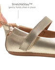 Close-up of the champagne gold leather baby shoe showing the Stretch and Stay elastic heel for a secure fit and easy dressing.