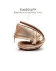 Demonstrating the flexible FlexiGrip sole on the metallic salmon kids shoe, designed for natural movement and play.
