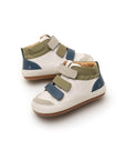 Angled view of baby Metropoly sneakers showing the triple-strap closure and premium leather panels.