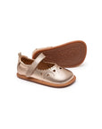 Metallic salmon leather baby Mary Janes featuring decorative heart cut-outs and a flexible rubber sole.