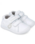 White baby sneakers with velcro straps on a white background