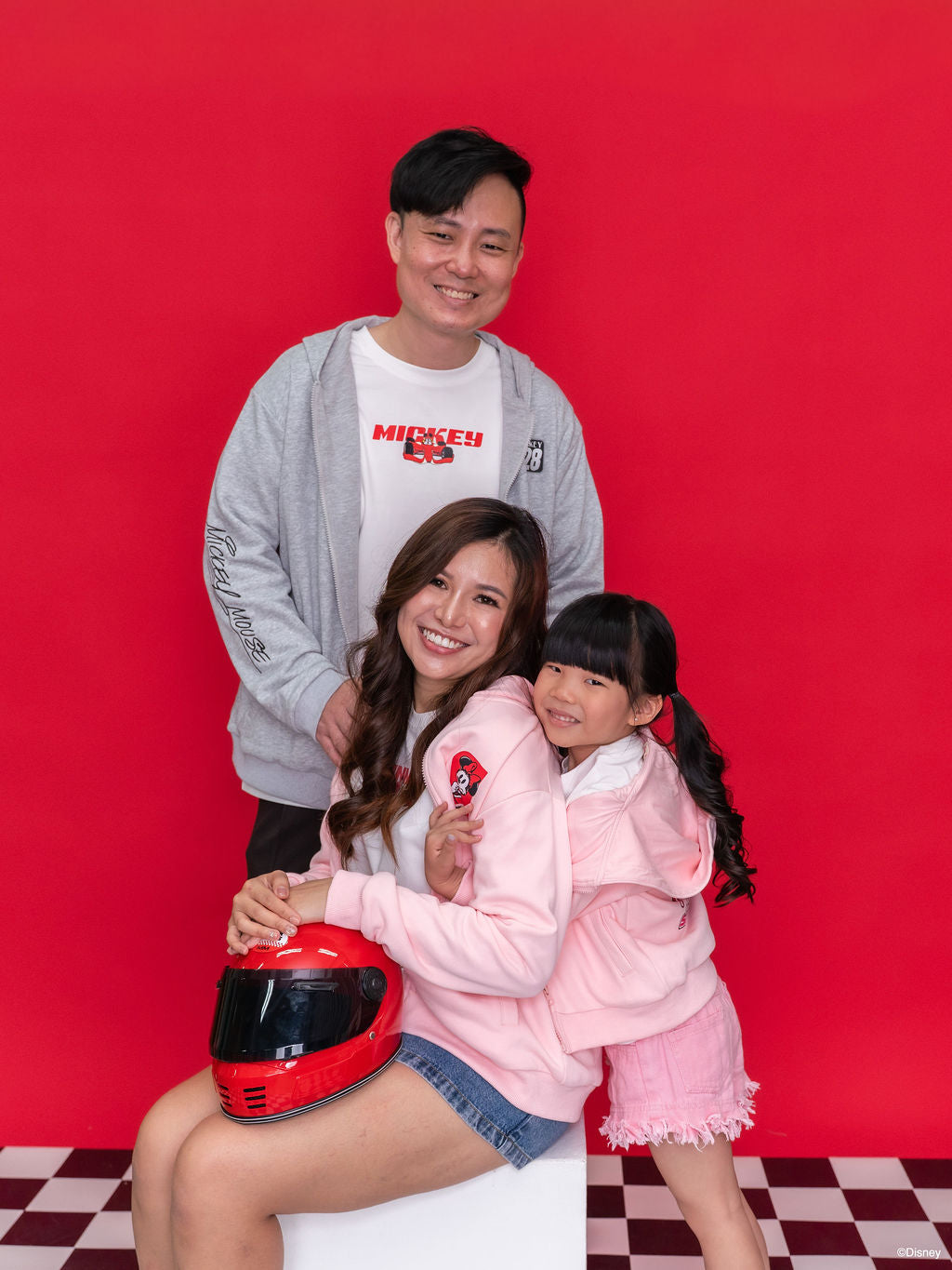 family wearing Mickey hoodies
