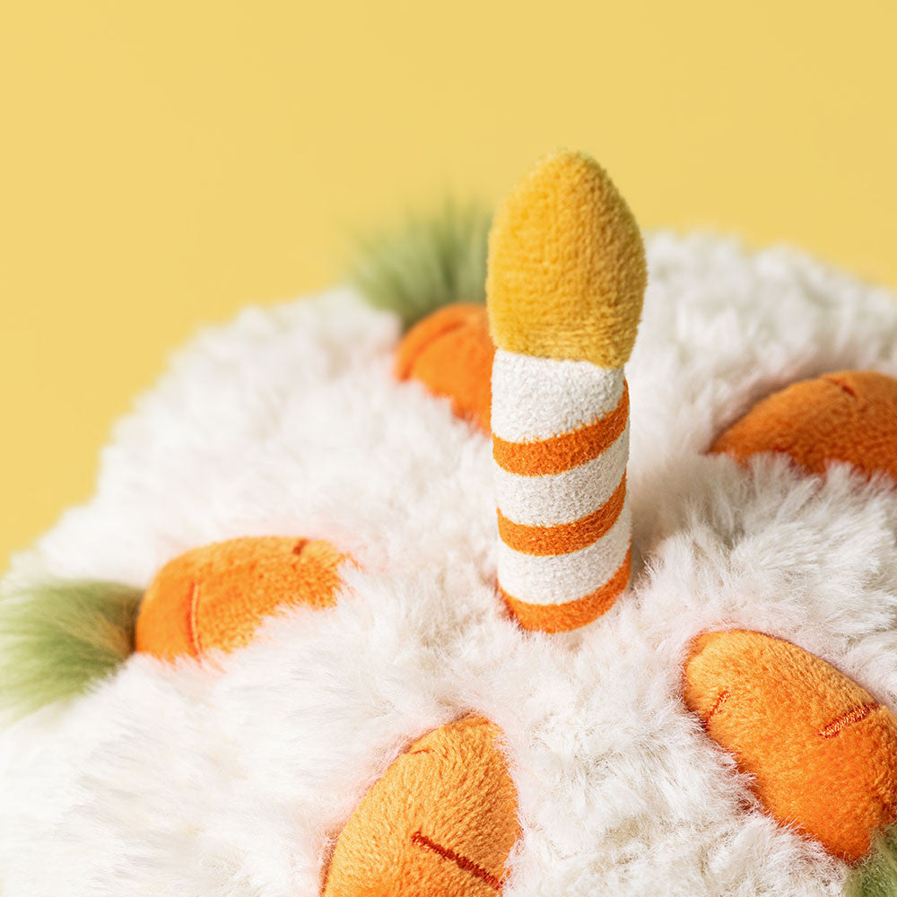 Close-up of a plush toy with orange and white striped legs on a yellow background