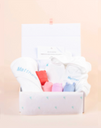 Personalised baby gift set with embroidered hooded towel and pastel animal toys in keepsake gift box