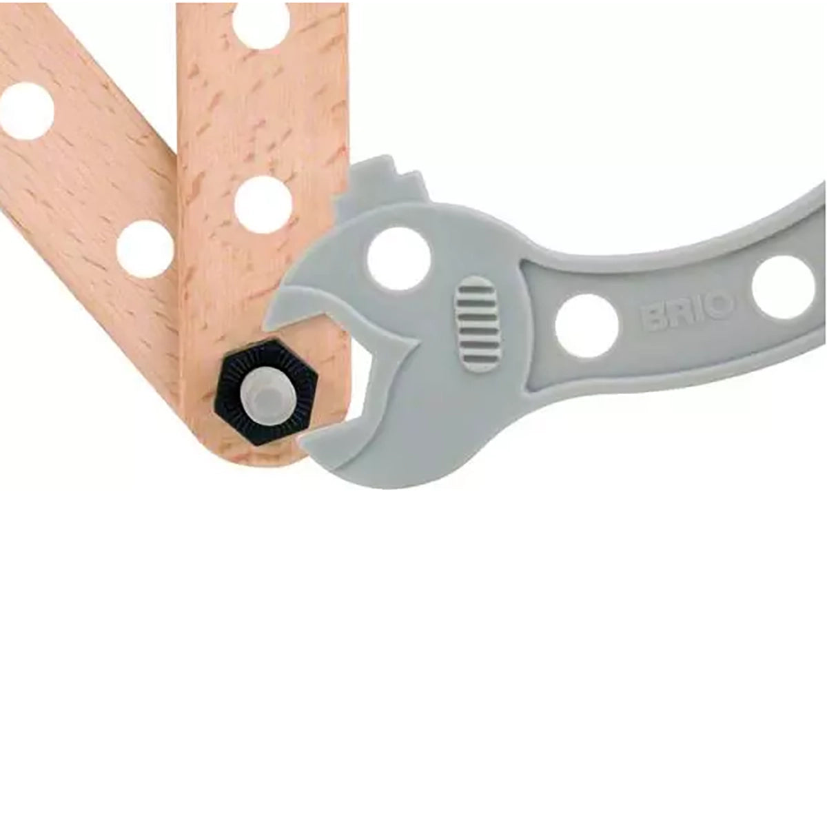 A close-up of a light gray Brio adjustable wrench tool with a hexagonal bit inserted, positioned over a wooden board on a white background.