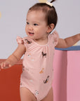 Baby in dog-print onesie smiles, DSC04013
