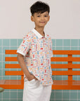 Childhood Games Polo Tee by Elly - Front view of boy in signature print.