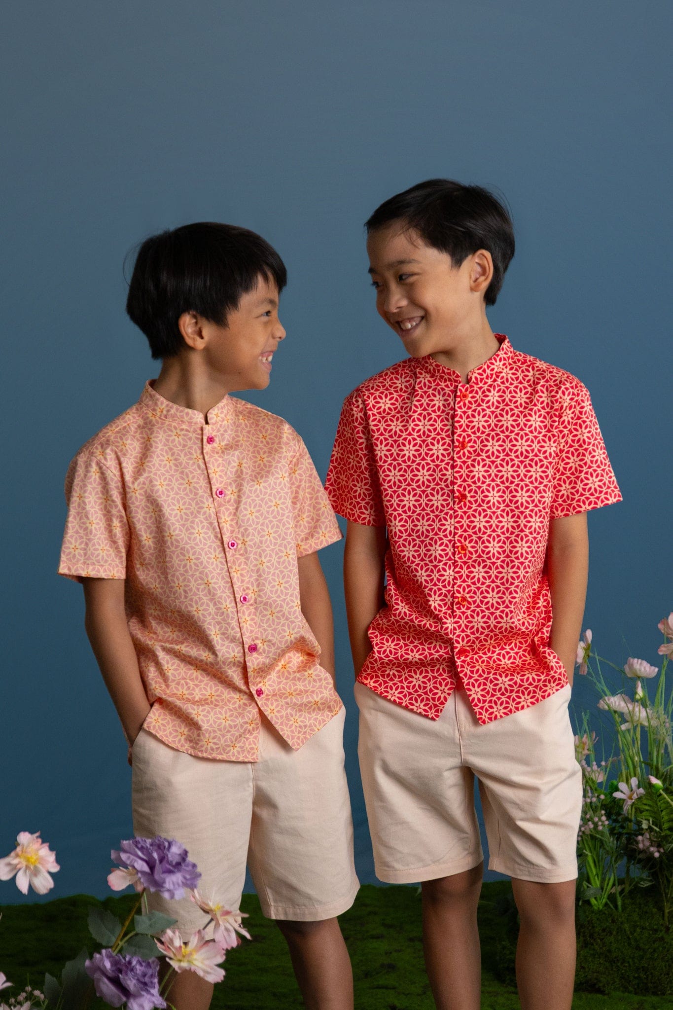 Two boys in patterned shirts and shorts