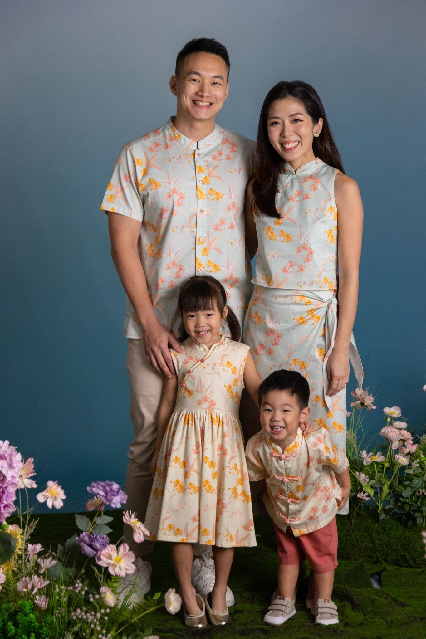 Family portrait in matching floral outfits.