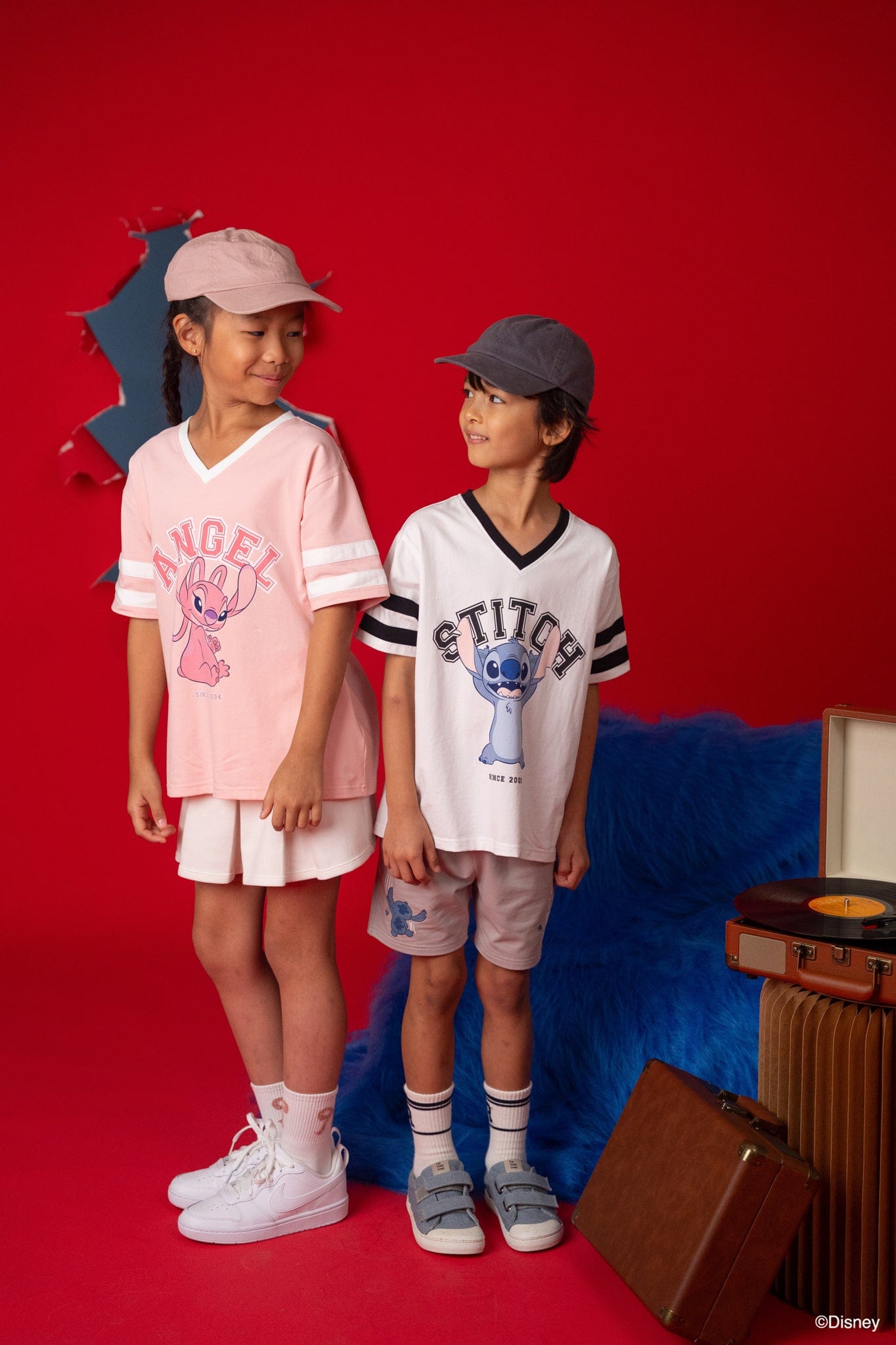 Stitch tee shirts with kids in front of red backdrop