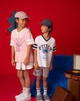 Stitch tee shirts with kids in front of red backdrop