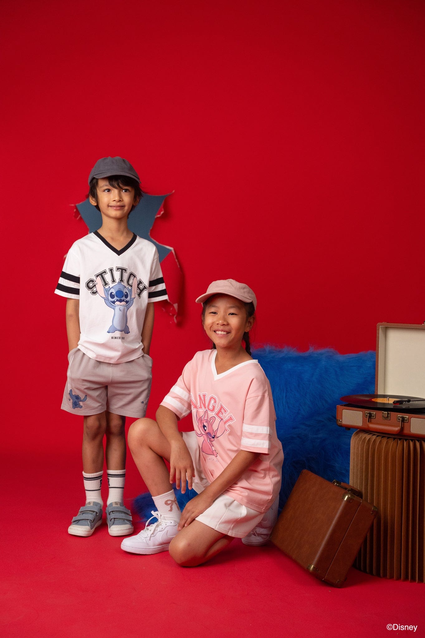 Kids wearing Stitch t-shirts on red background
