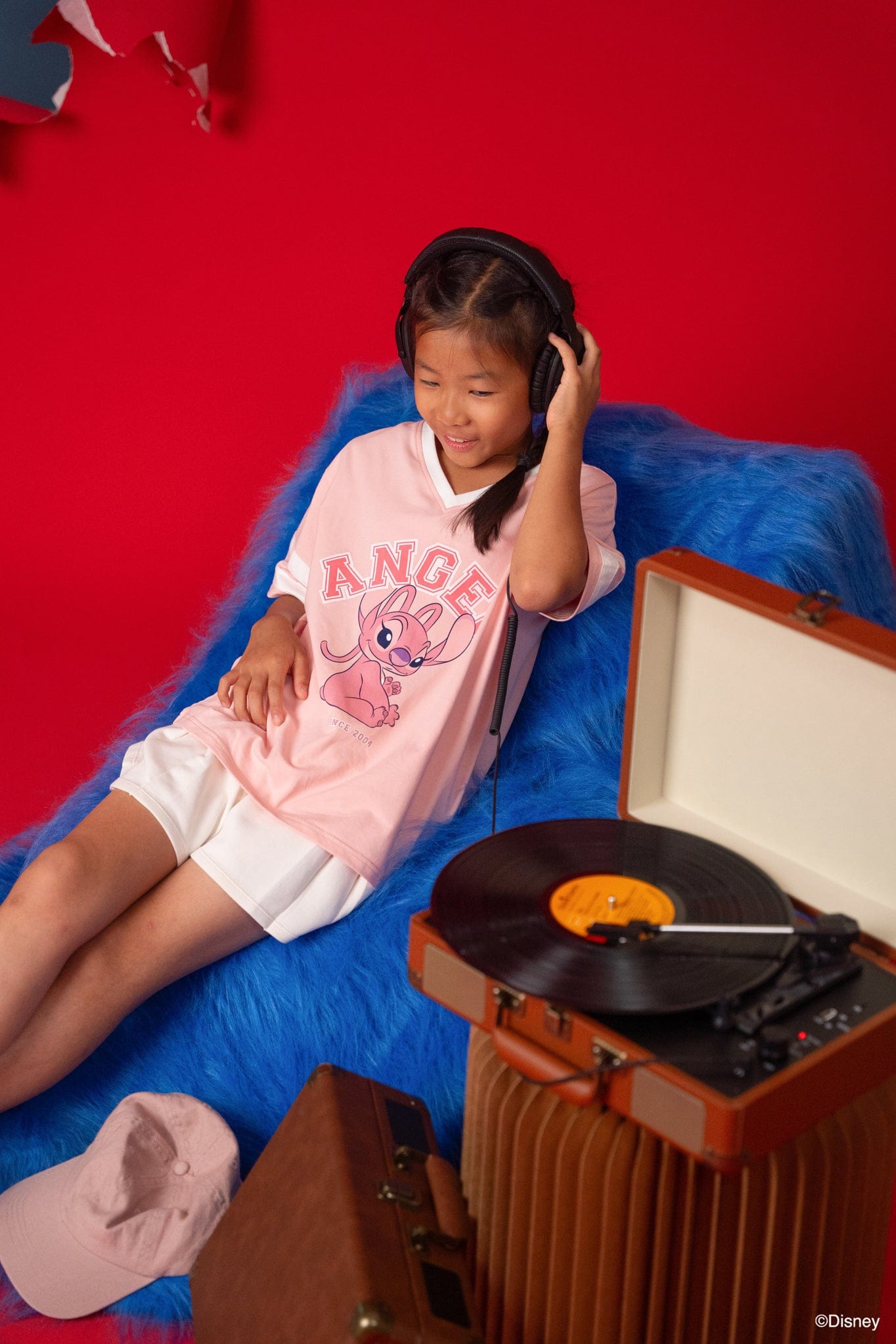 Girl wearing Stitch tee shirt with record player