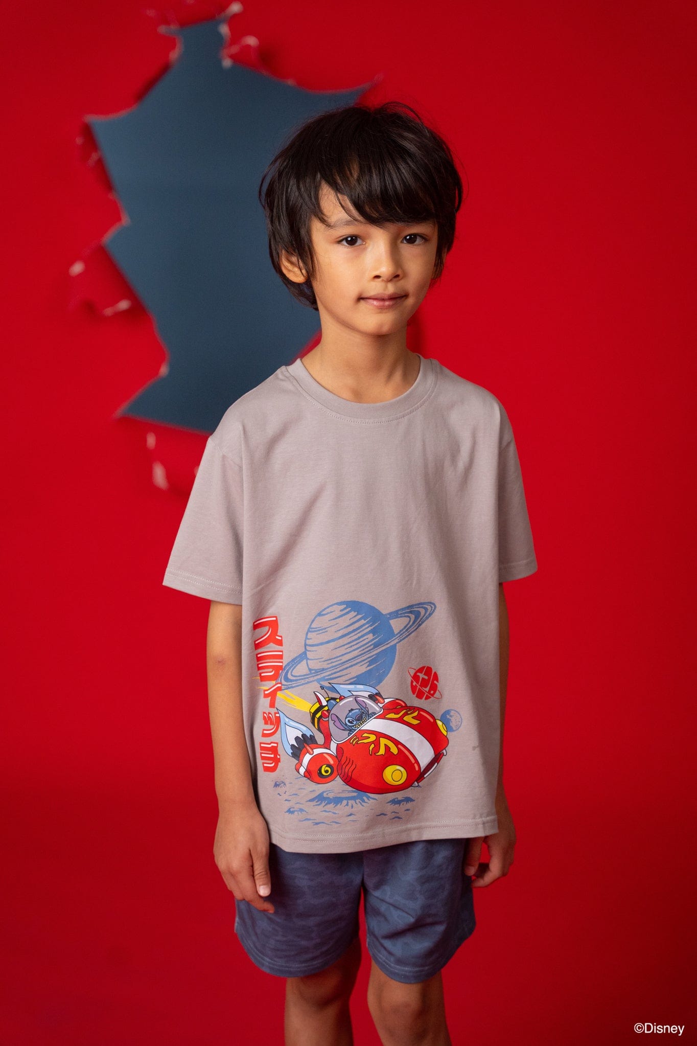 Boy in Stitch tee shirt with space design