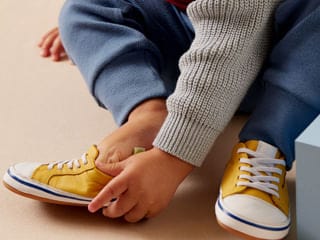 Child in yellow sneakers
