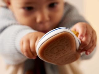 Baby holding shoe - TTJ thintofeel