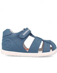 Blue children's sandal with white sole on a white background