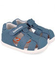 Blue children's sandal with white sole on a white background