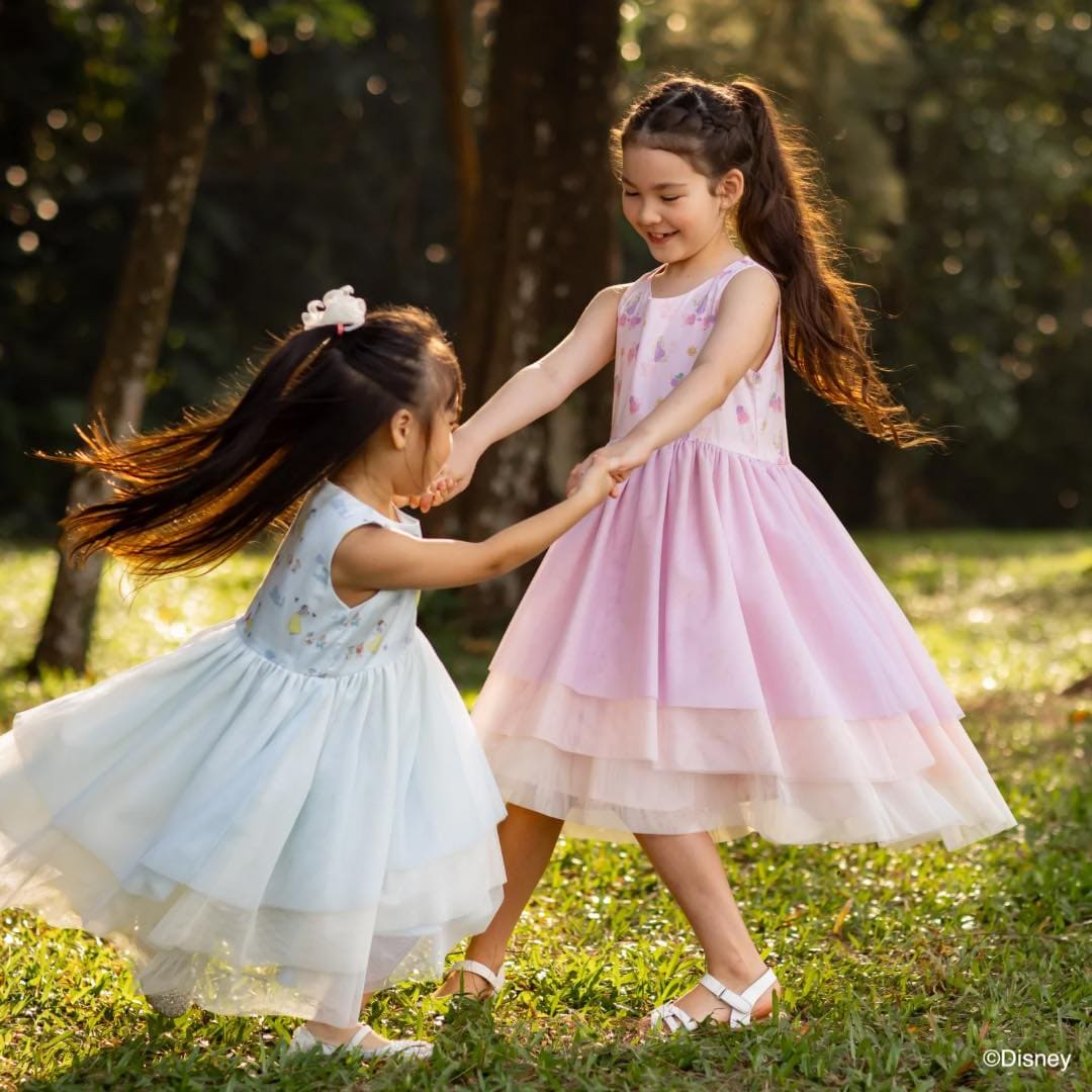 Two girls dancing in dresses