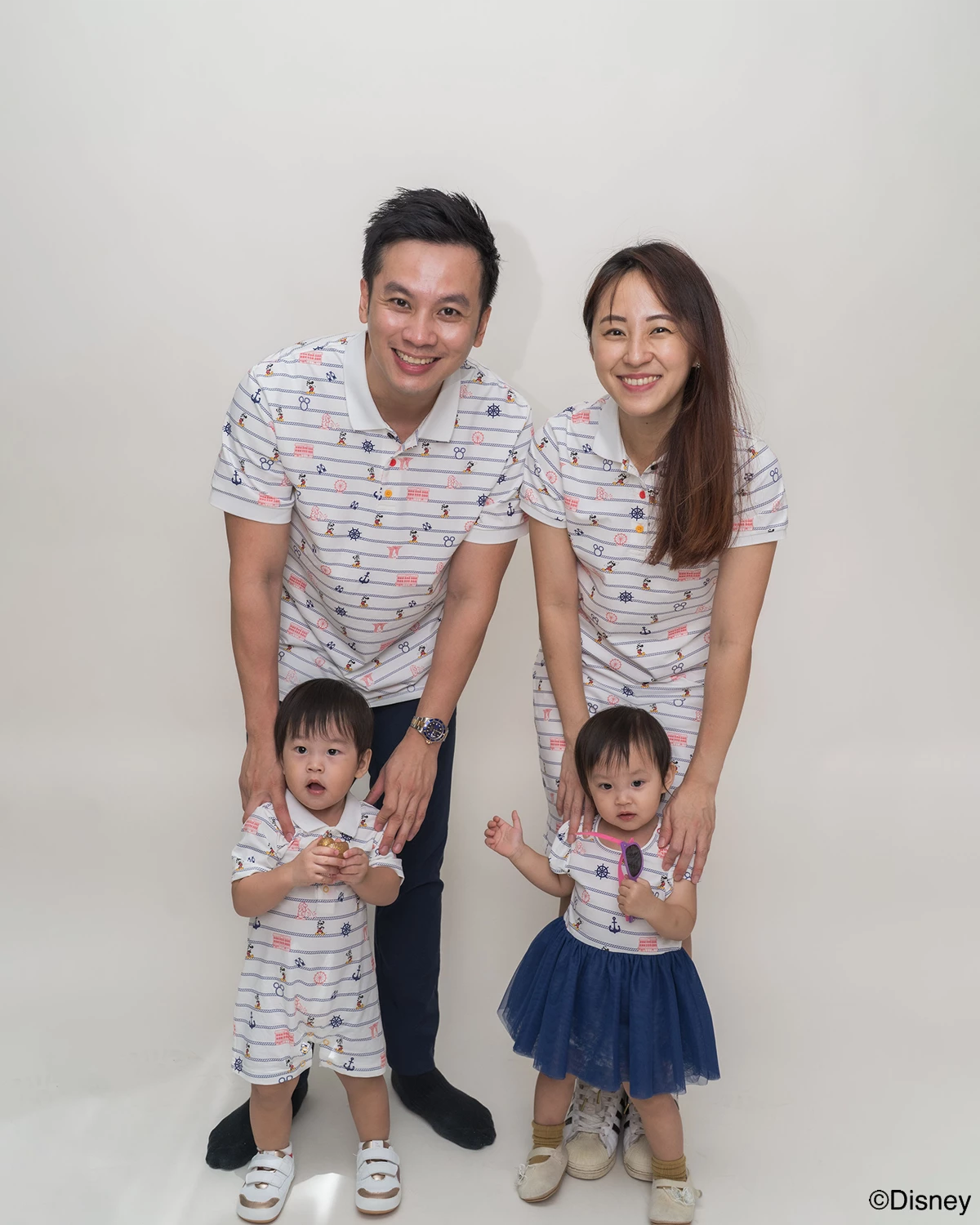 Family of four wearing matching  Nautical Mickey design 