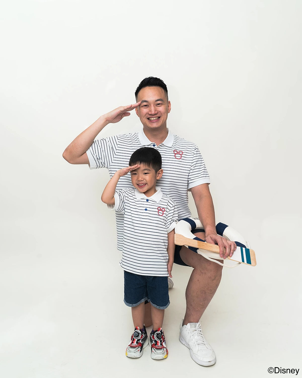 father and son in matching stripes sailor mickey polo tees 