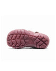 View of the dark pink rubber outsole, featuring a multi-directional lug pattern for high-traction grip.