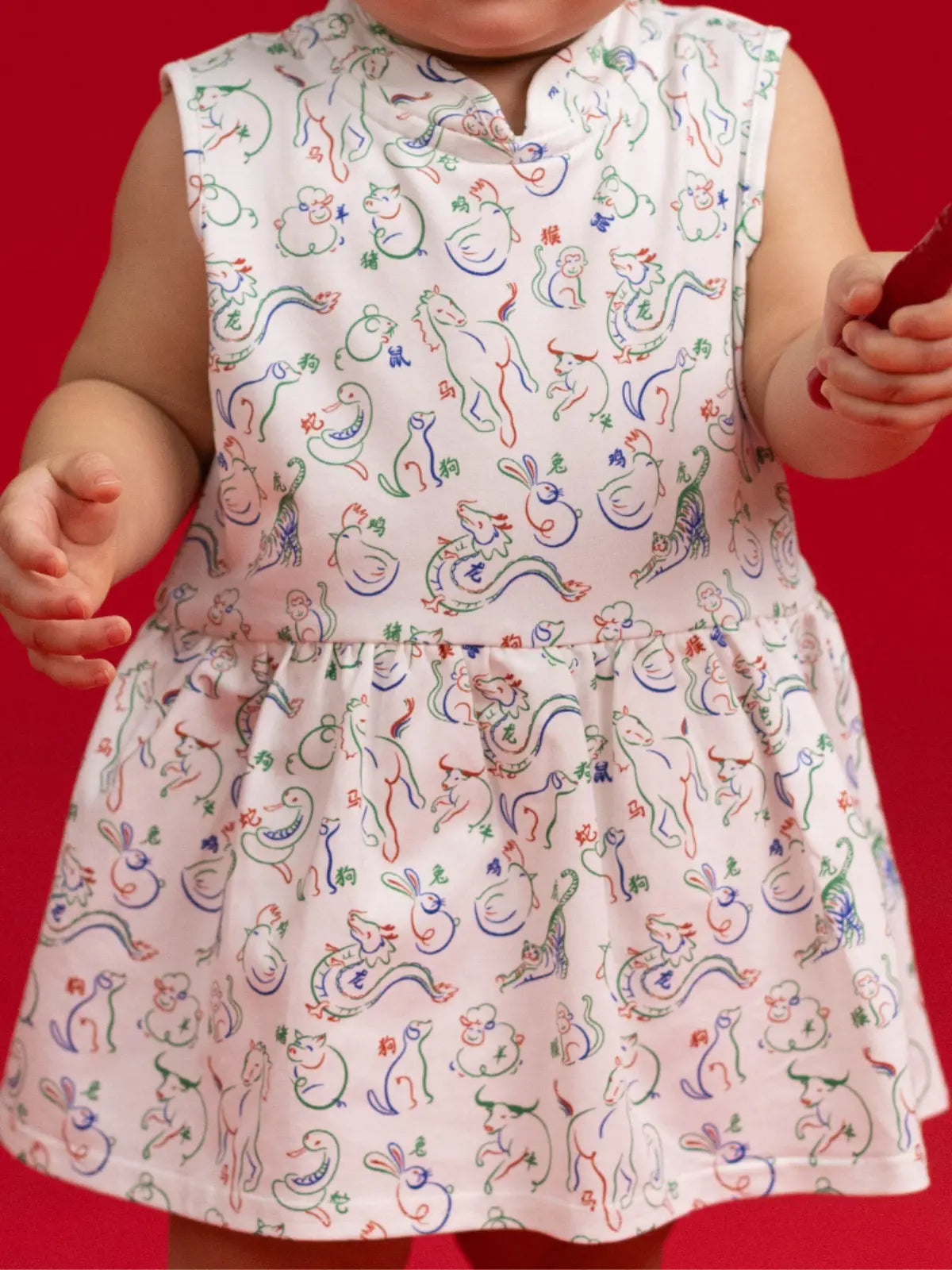 Close-up of the Elly Zodiac Mahjong print detail on the Kira Onesie fabric.