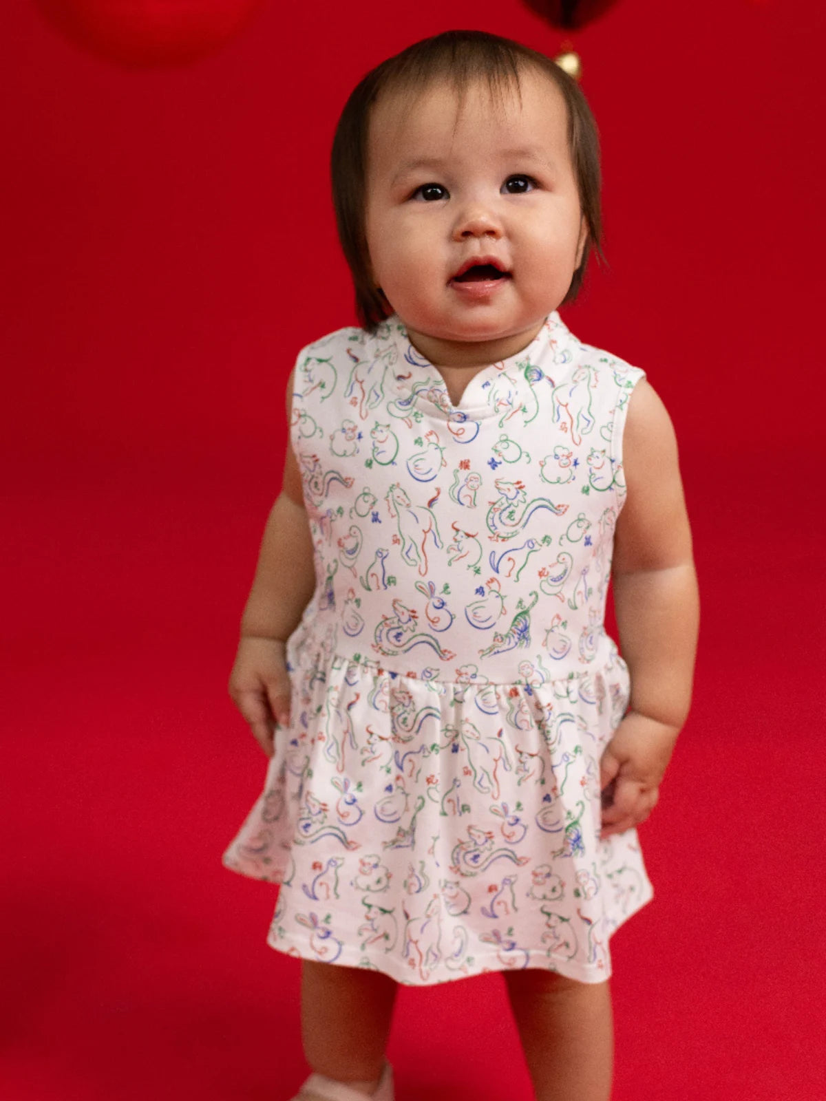 Full body view of the Kira Onesie by Elly in white Zodiac Mahjong print.