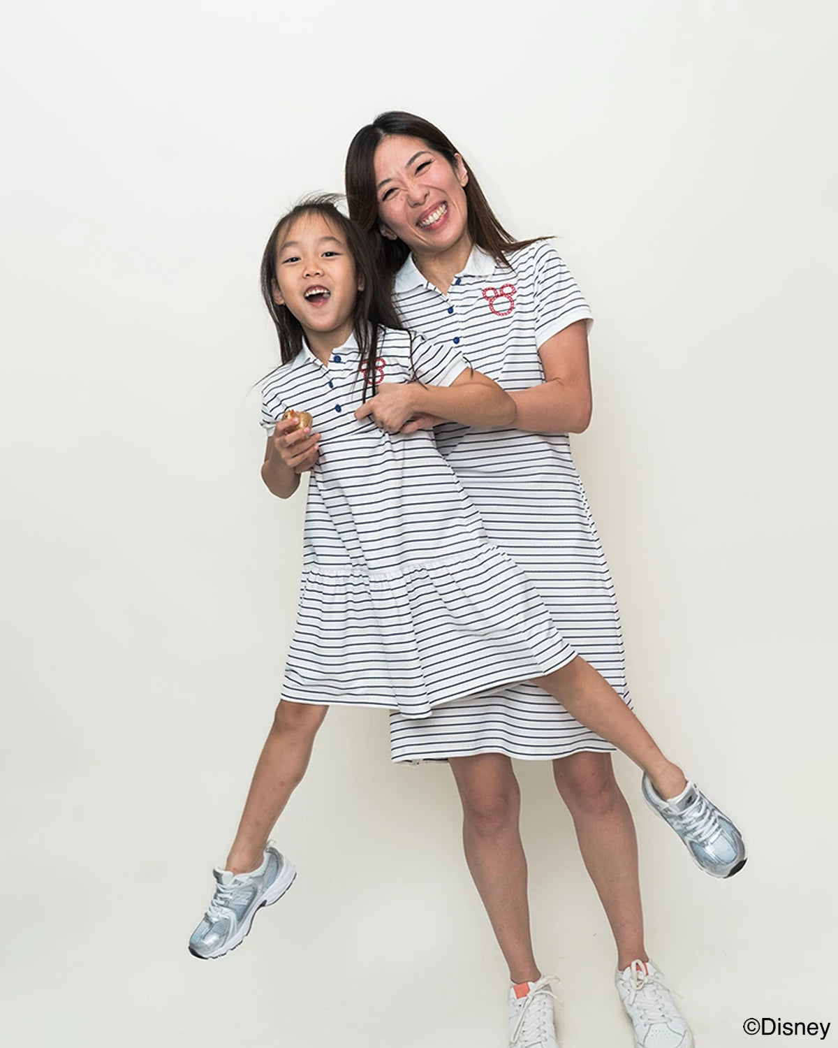 mother and daughter wearing matching sailor mickey stripes outfits 