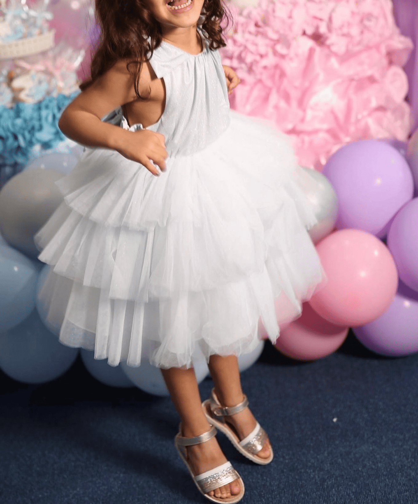 girl in white tutu dress with gold sandals