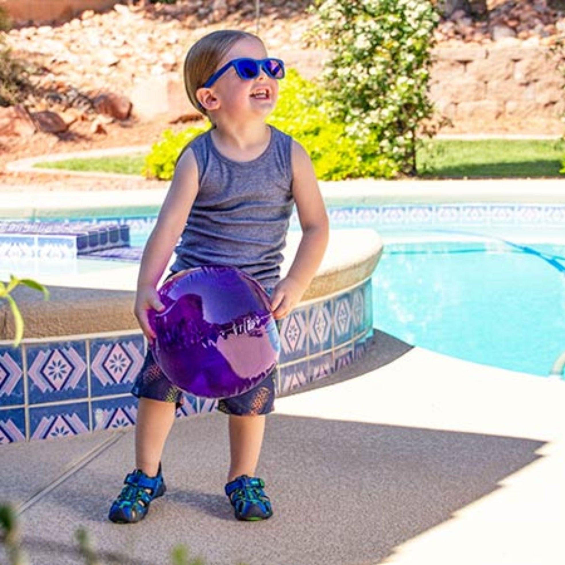 Boy by pool with ball