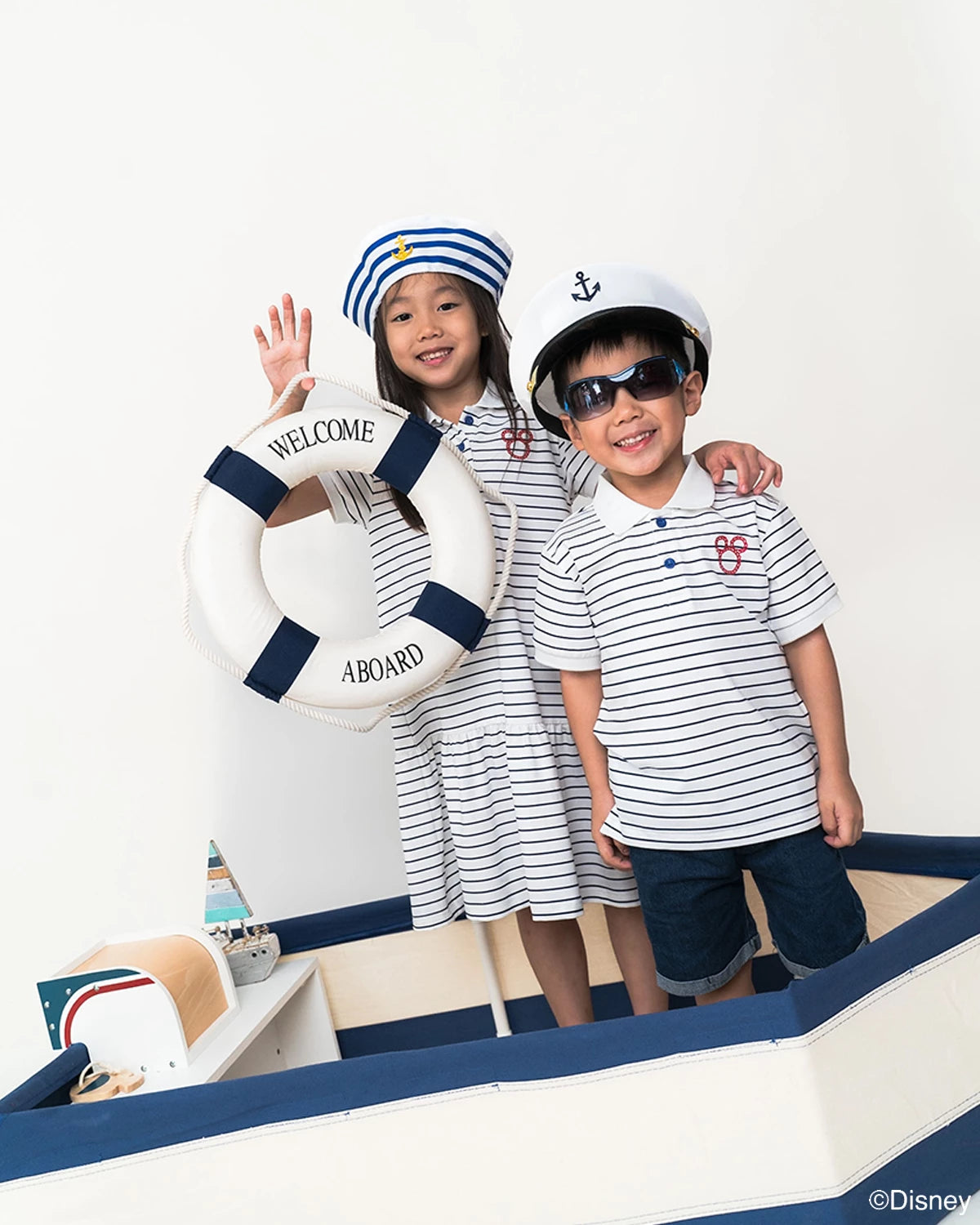 Two children in matching nautical mickey outfits 