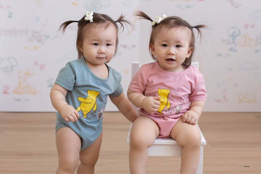Twin babies in rompers