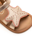 Angled view of a pair of Tip Toey Joey Starfish Sandals in Metallic Salmon / Rosa Seco / Golden Sugar