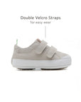 Side view of the Pumice Bossy sneaker highlighting the double velcro straps for an adjustable, secure fit.